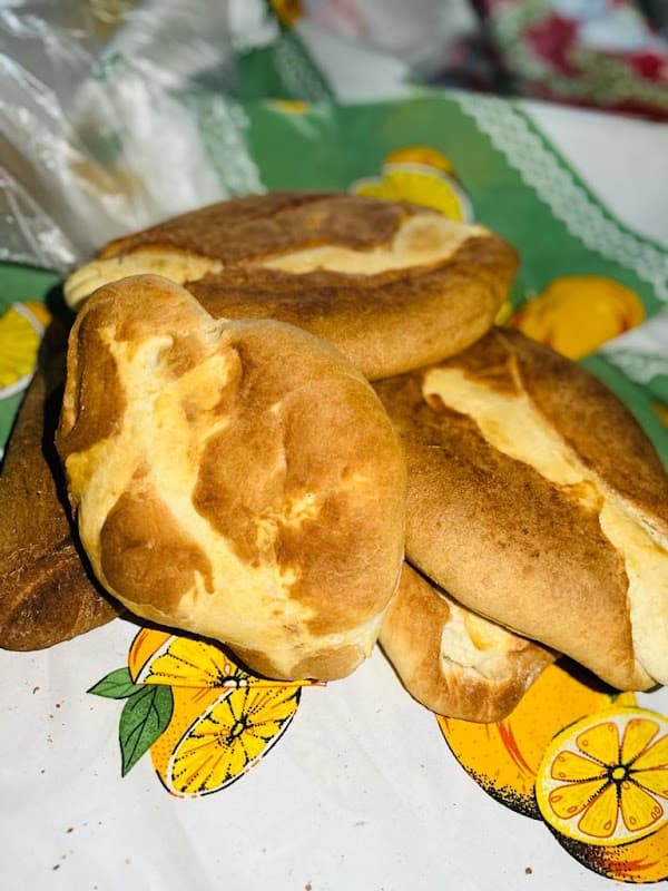 Panadería Oponguio mostrando su mostrador lleno de panes artesanales y empanadas de camote — vista interior con luz natural