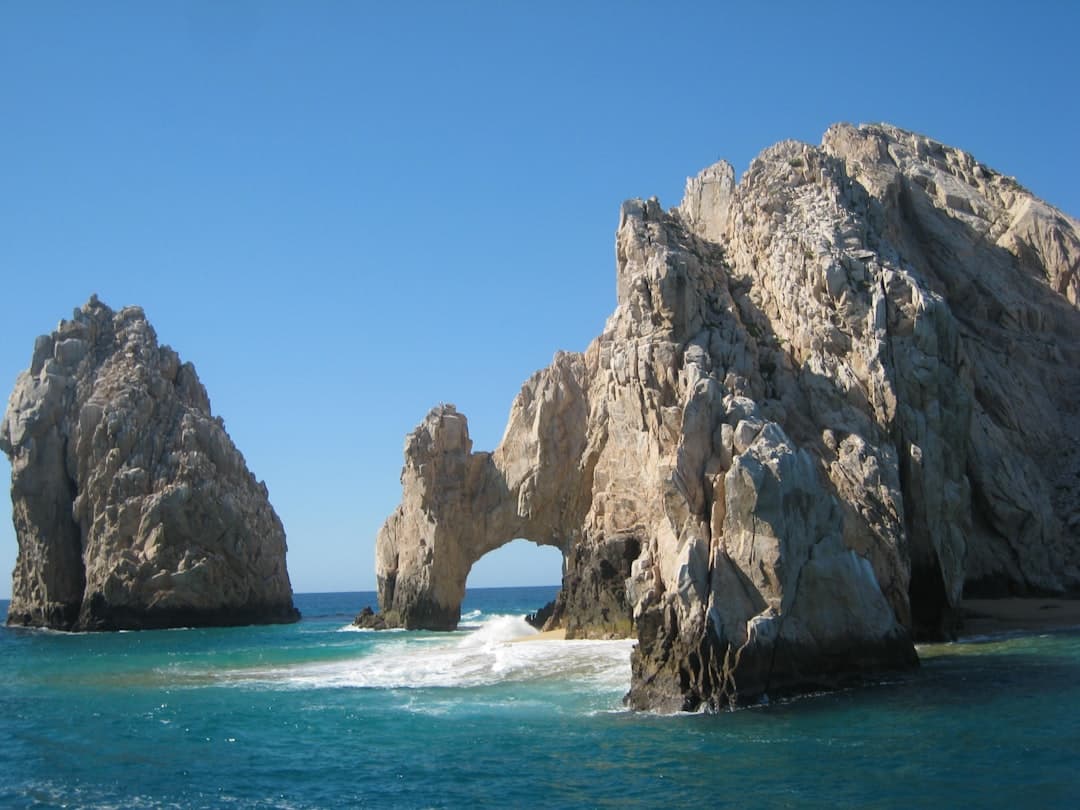 A large rock formation in the middle of the ocean