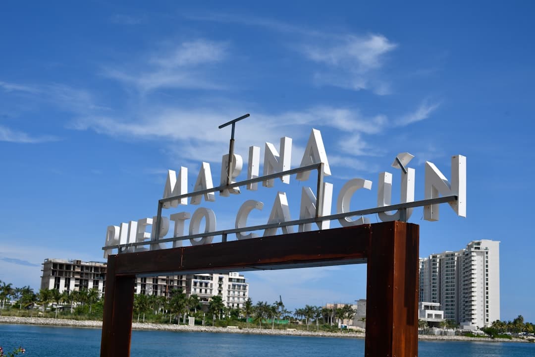 Marina puerto cancun sign with buildings and water