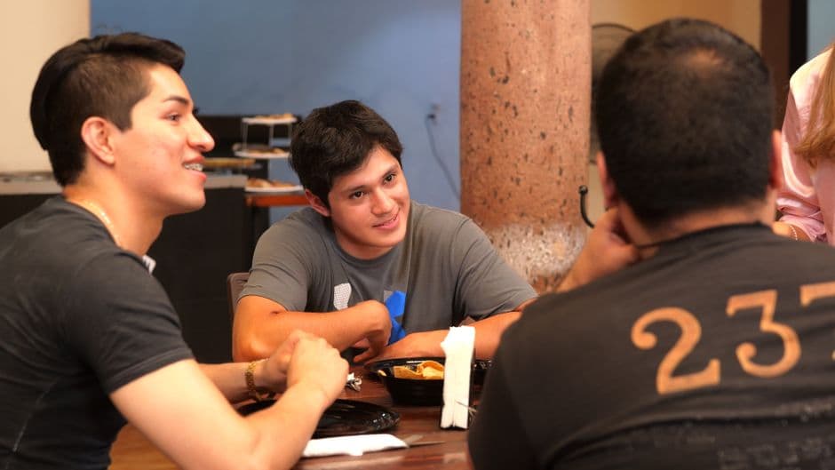 Young adults enjoying a meal together at a restaurant in Guanajuato, Mexico.