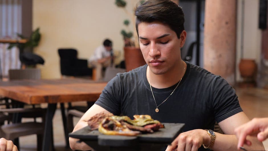 Young man enjoying traditional Mexican food at a restaurant in Guanajuato, Mexico.