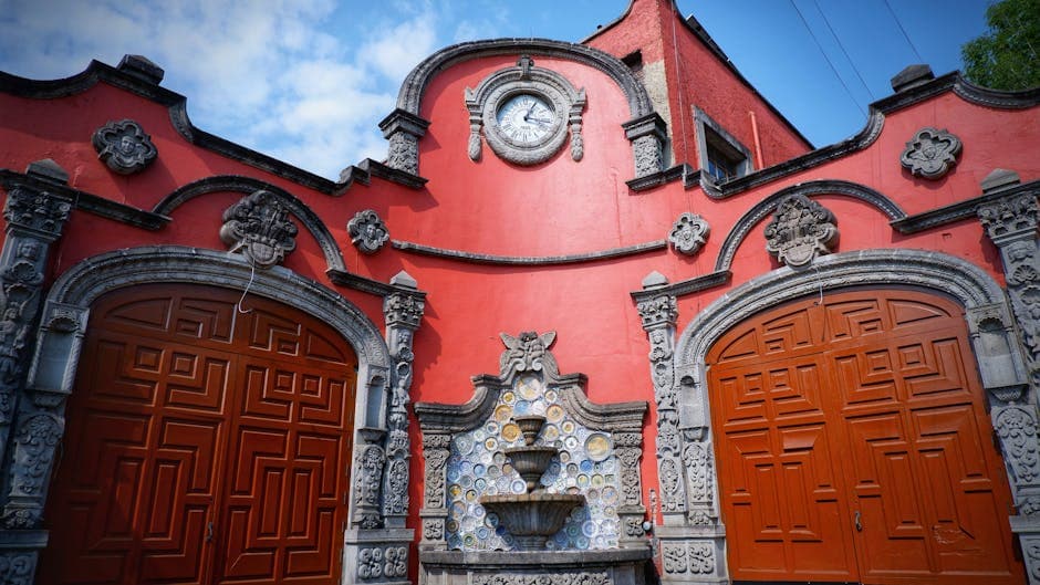 Historic architectural facade in CDMX featuring a clock tower and decorative elements.