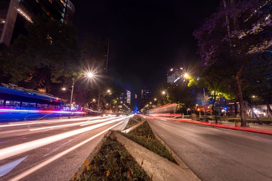 Captivating night scene in Mexico City featuring light trails and urban architecture.