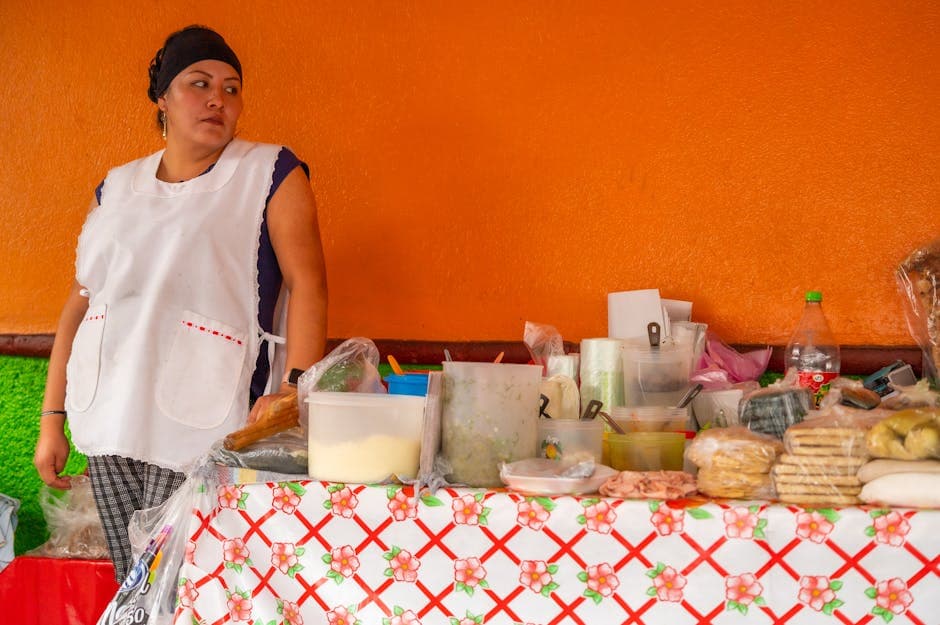 A street vendor in Ciudad de México displaying traditional Mexican foods on a colorful table.