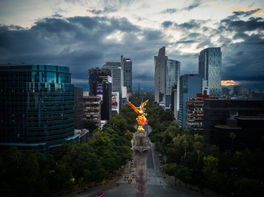 Stunning evening view of Angel of Independence with Mexico City skyline.
