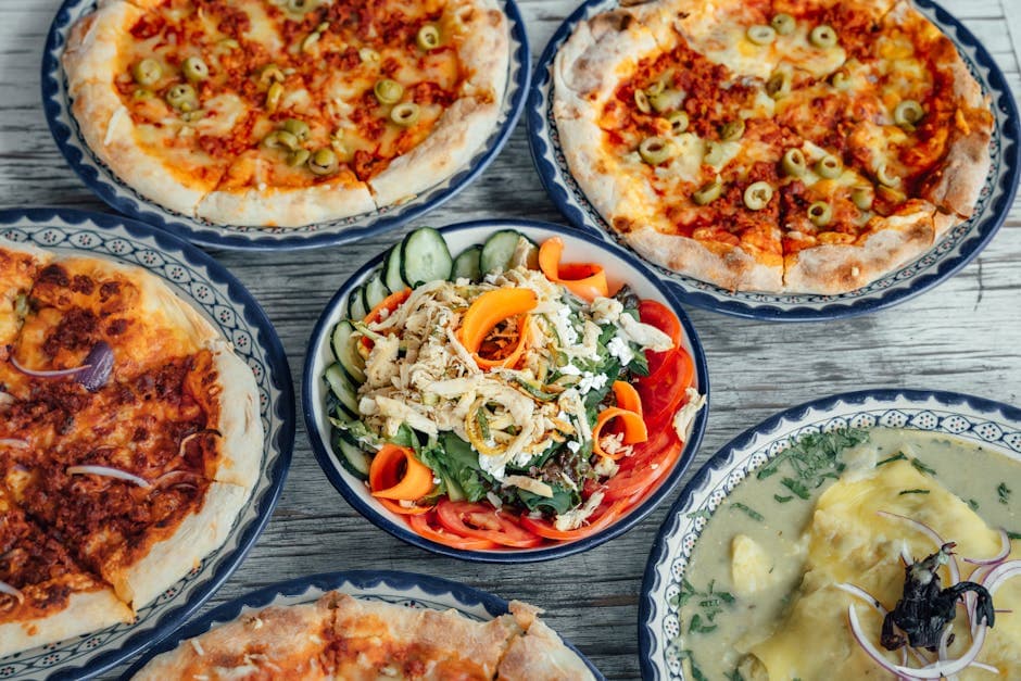 A variety of pizzas and a fresh salad served in traditional Mexican style in Lerma, Mexico.