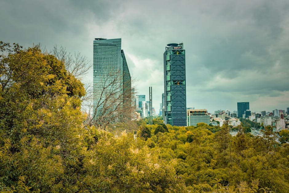 Explore the modern skyscrapers amidst lush greenery in Mexico City.