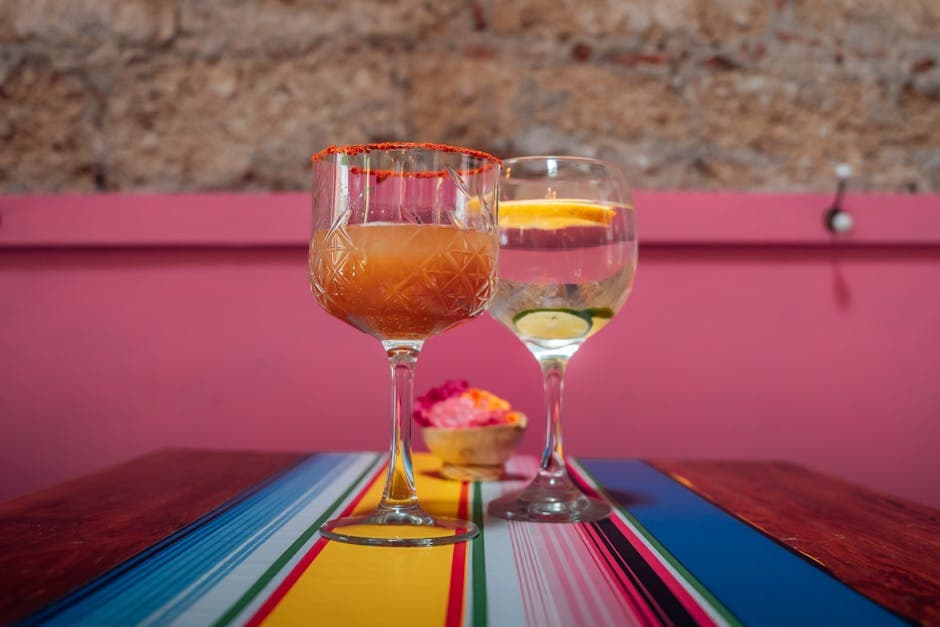 Vibrant cocktails served on a colorful tablecloth in a cozy Mexican setting, perfect for festive gatherings.