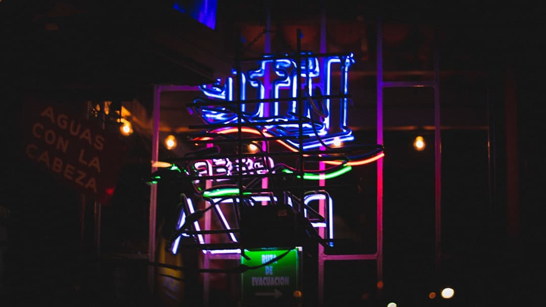a neon sign is lit up in the dark