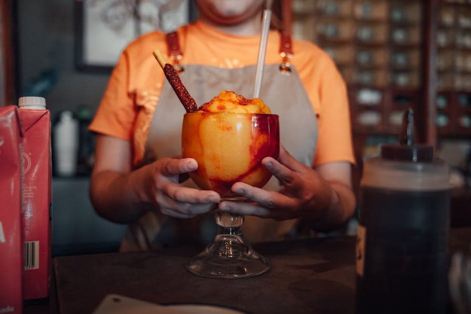 A vibrant Mexican drink with tamarind and chamoy served indoors at a restaurant in Mexico.