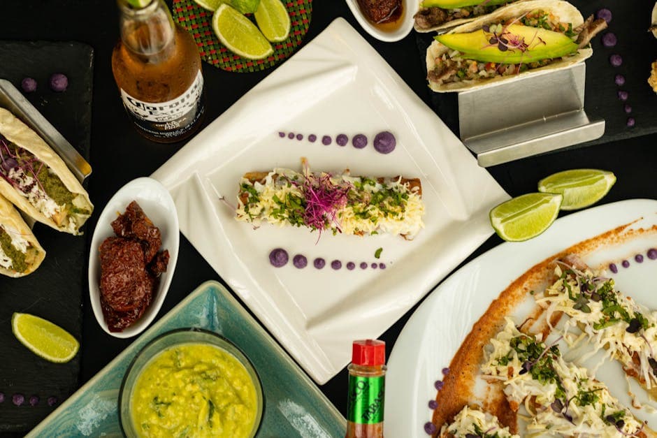 A vibrant display of Mexican dishes featuring tacos, sauces, and beverages.