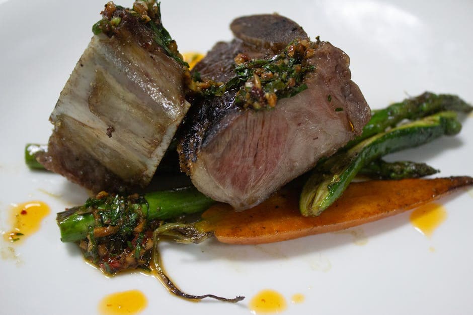 Delicious wagyu beef with asparagus and sauce, perfect for gourmet dining.