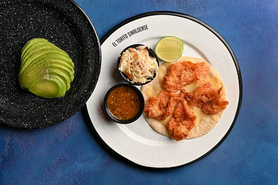 A vibrant seafood plate with avocado slices, served at El Torito Sinaloense, perfect for food photography.