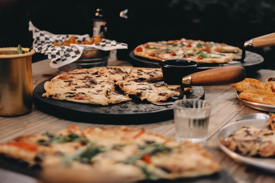 a table topped with lots of different types of pizza