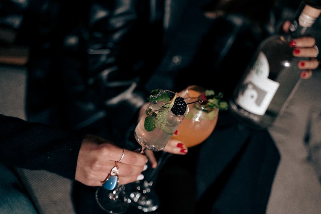 a close up of a person holding a drink