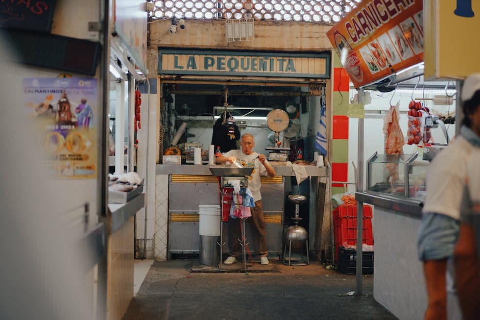 A vendor prepares food at a small market stall called La Pequenita in Mexico.