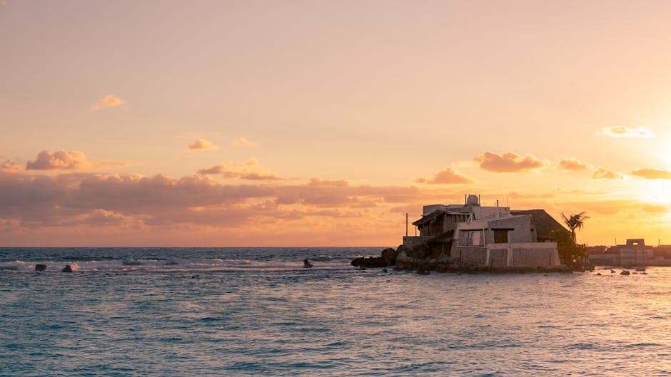 Golden sunset over a picturesque seafront villa on Isla Mujeres, Quintana Roo, Mexico.