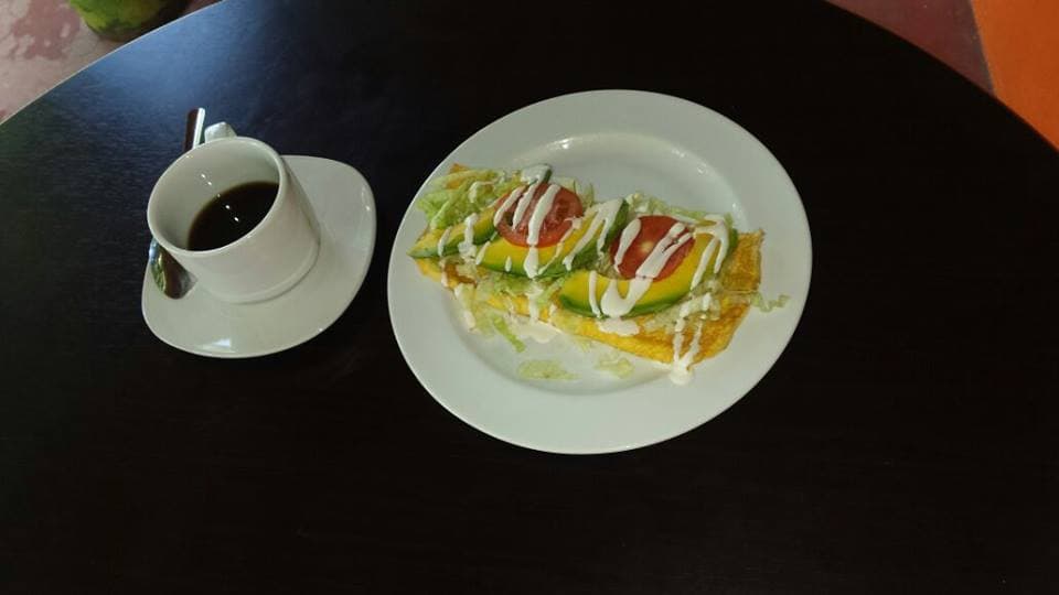 Loncheria Angelíca fachada con letrero rojo y mesas al aire libre, mostrando tacos y panuchos en la barra
