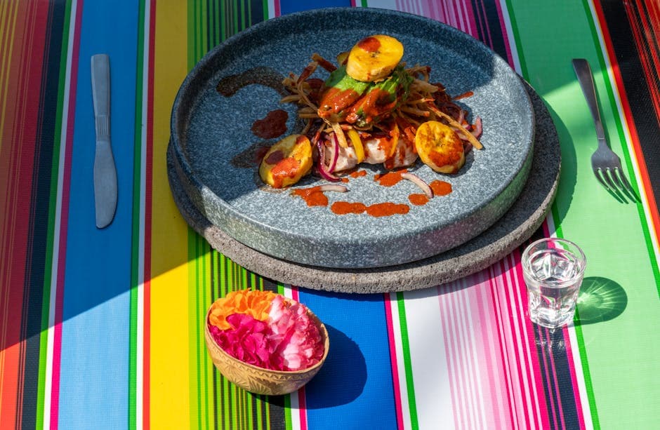 Colorful Mexican meal setting with vibrant tablecloth and dish in Mexico City.