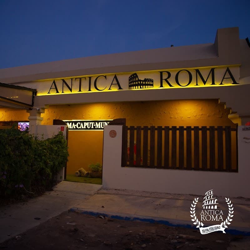 Antica Roma storefront on Calle 23 A with wooden sign and morning light, showing the terrace and a glass of sangría on a table