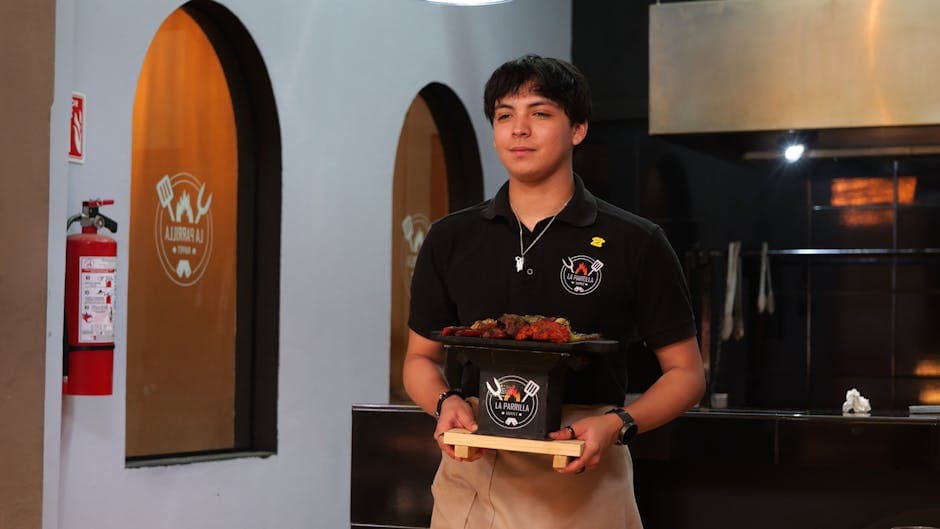 Waiter serves traditional Mexican grill at La Parrilla Steak House in Guanajuato.