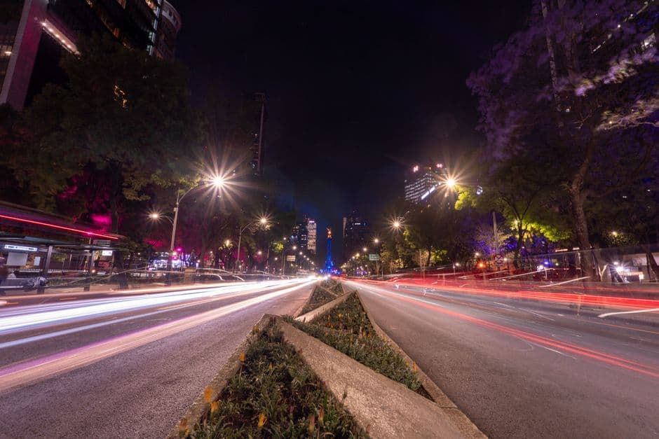 Dynamic long exposure of city traffic at night with colorful lighting in Mexico City.