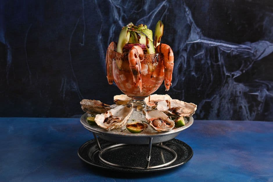 Mouthwatering seafood tower featuring shrimp and oysters, perfect for gourmet food lovers.