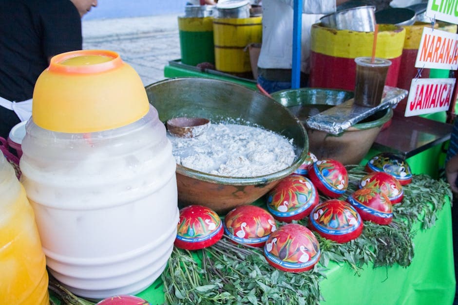 Colorful display of traditional food and drinks at a vibrant street food stand in Oaxaca, Mexico.
