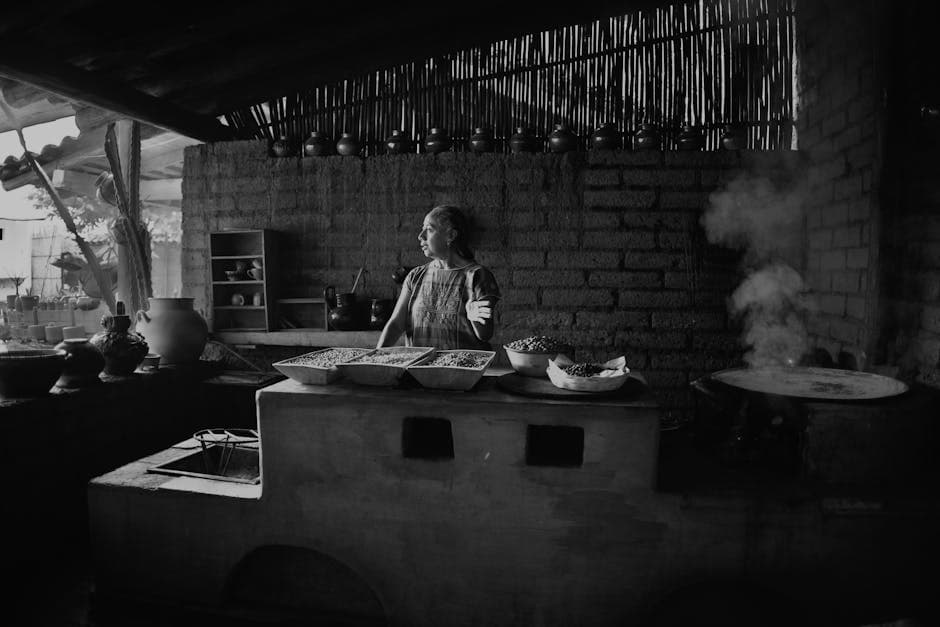 A woman cooking in a traditional Mexican kitchen in Oaxaca, with rustic elements and pottery.