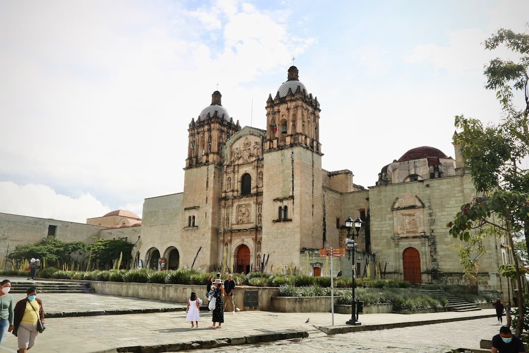 a group of people standing in front of a large building