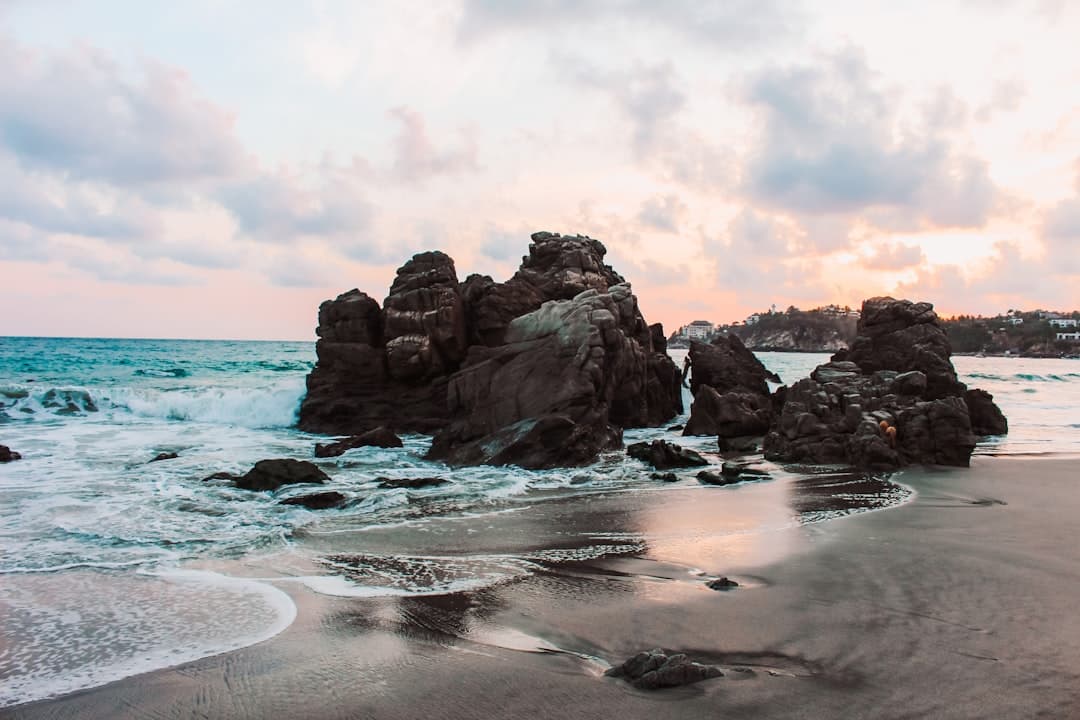 a rocky beach with waves coming in to shore