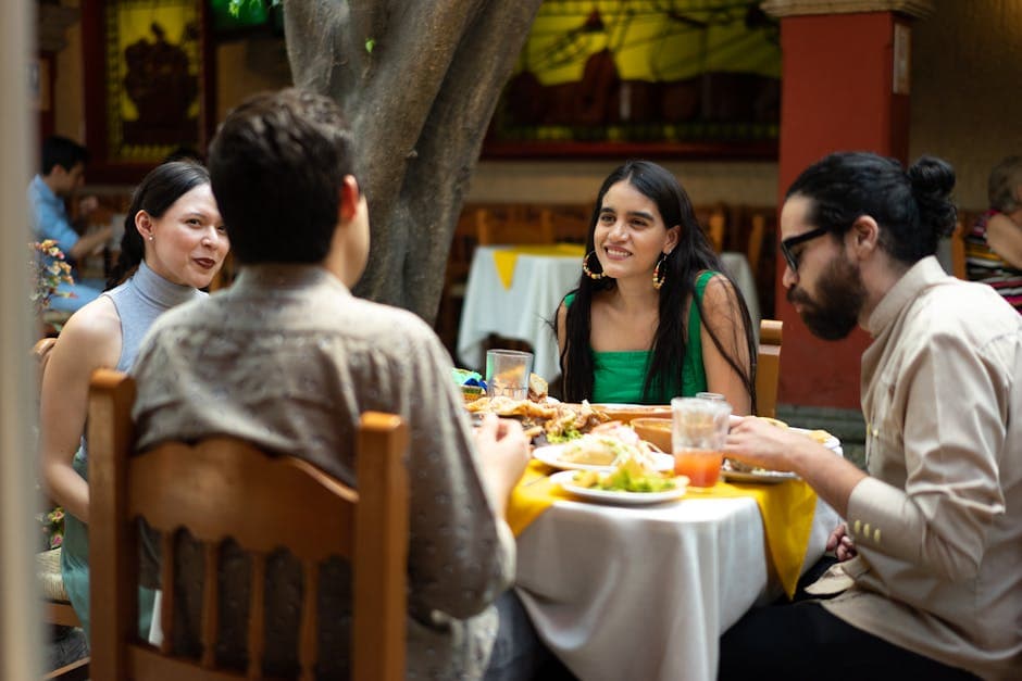 A group of friends enjoying Mexican cuisine outdoors at a vibrant restaurant.