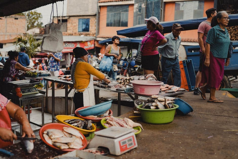 Vibrant scene of a fish market in Rioja, Peru, with vendors and customers interacting.