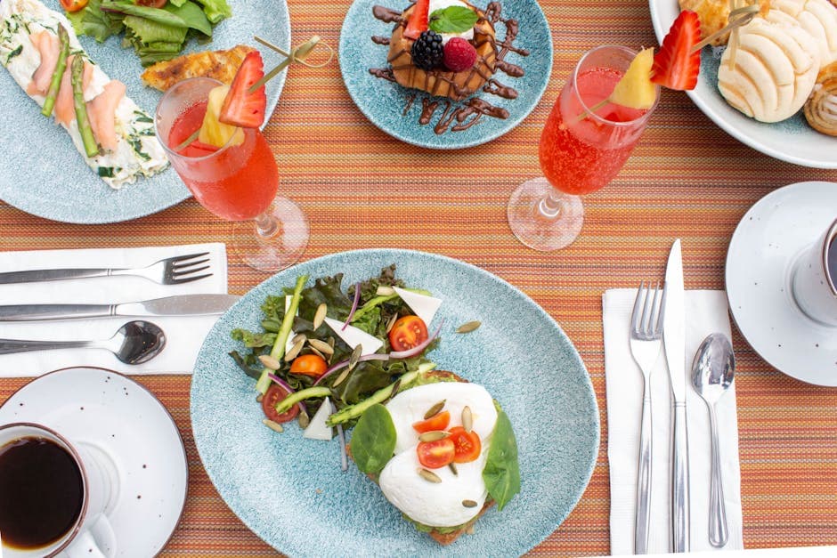 A vibrant breakfast table setting in Puerto Vallarta with fresh salad, pastries, and drinks.