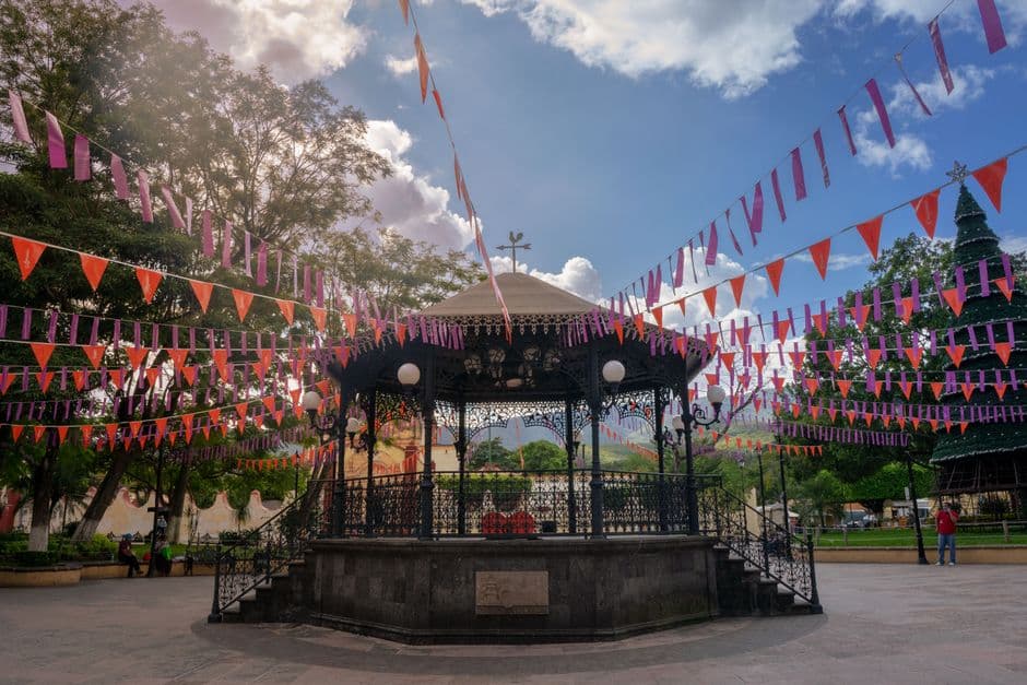 Colorful bunting adorns the gazebo in Jalpan de Serra, creating a festive atmosphere.
