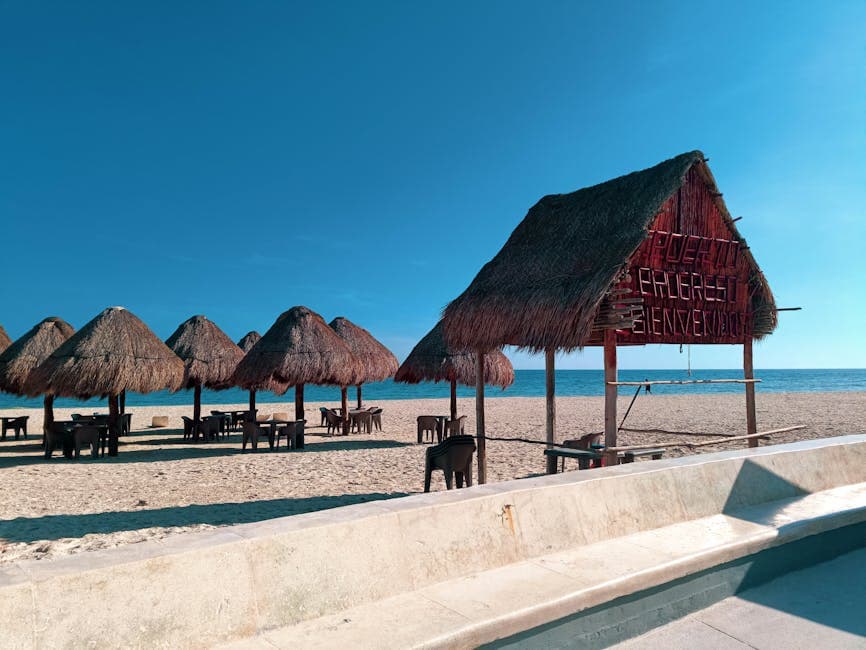 Idyllic scene of palapa huts on Progreso Beach, Yucatán under a clear sky.