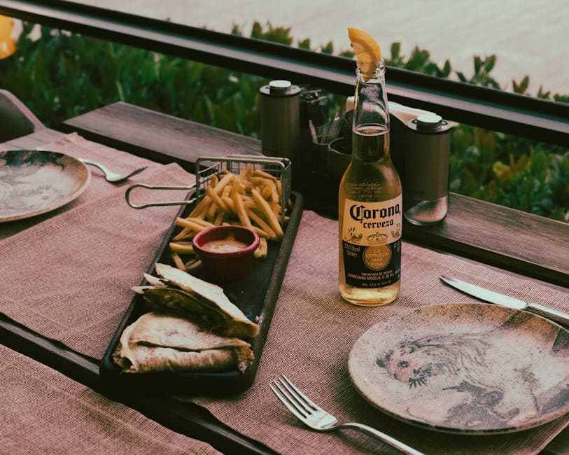 A cozy outdoor dining setup featuring beer, French fries, and quesadillas, perfect for a casual lunch.