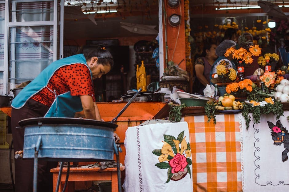 A woman works at a vibrant market stall in Janitzio, Michoacán, Mexico, showcasing local culture.
