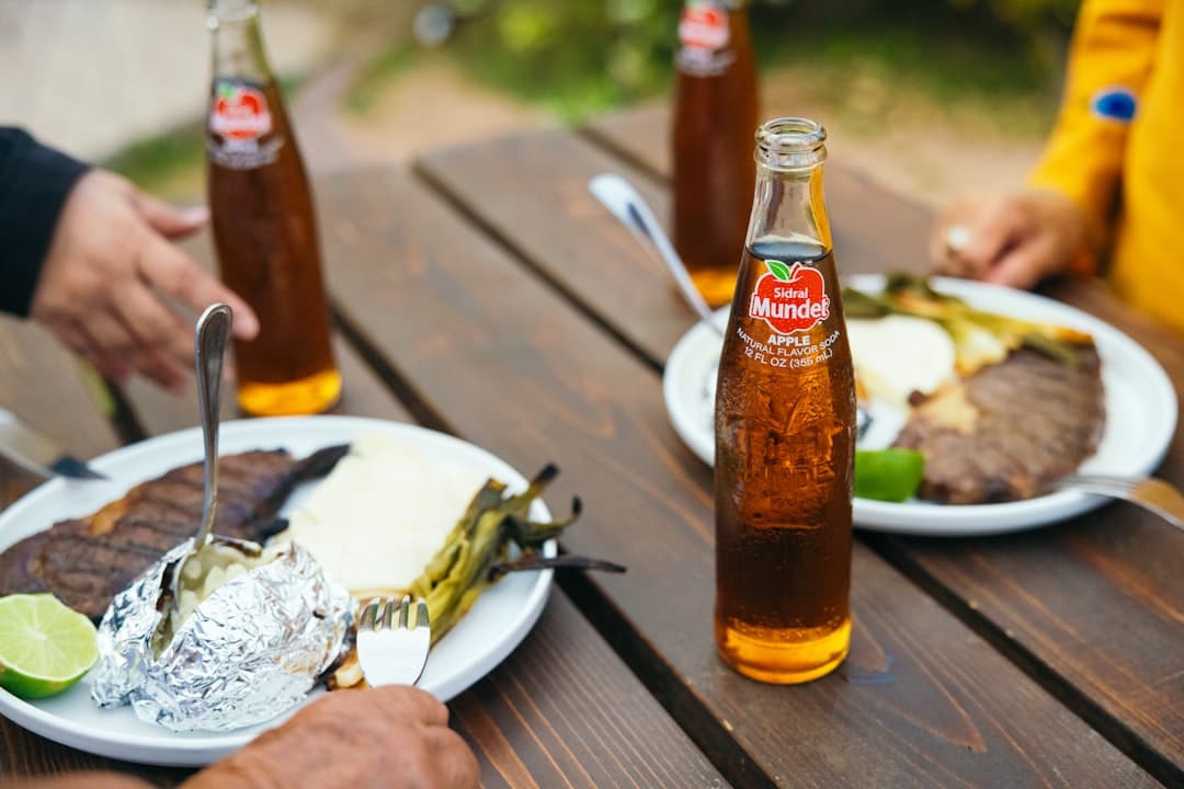 a couple of people sitting at a table with plates of food