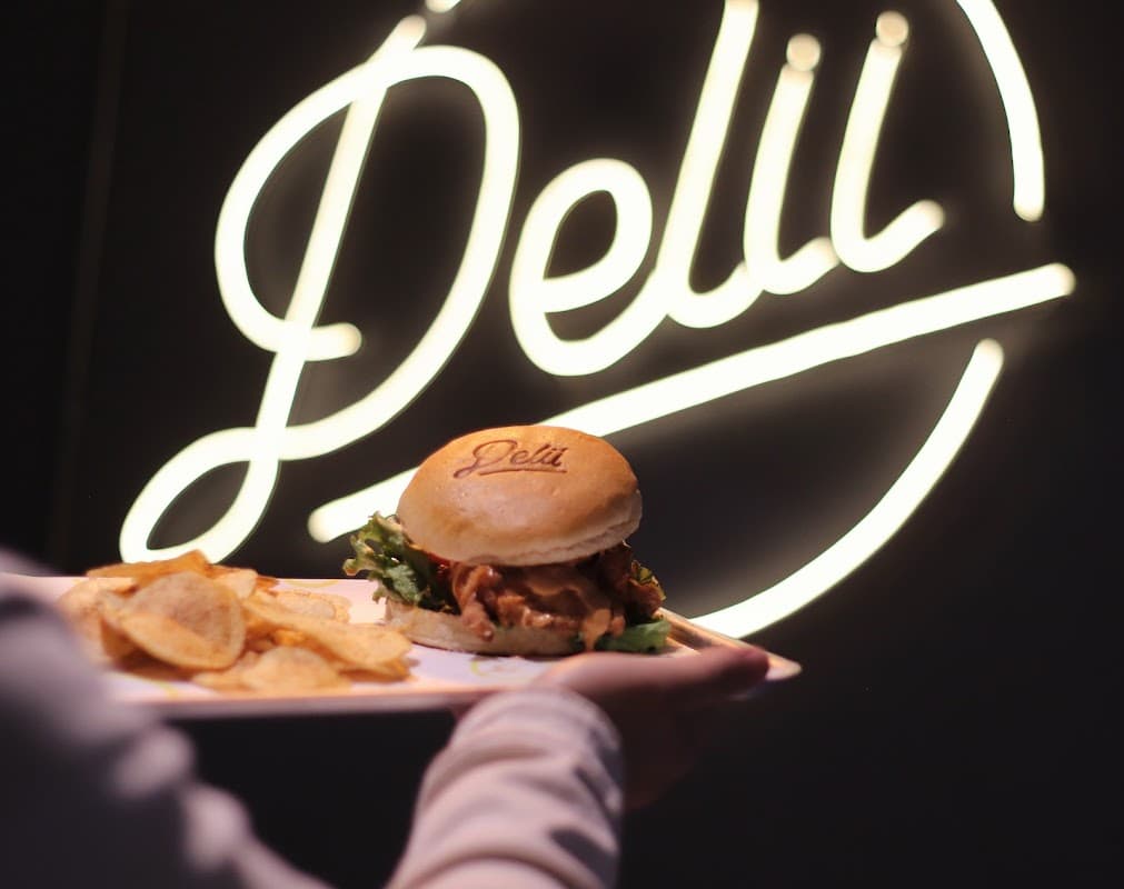 Delii Chicken Sandwich storefront on Allende 2 with the golden chicken sandwich displayed in the window