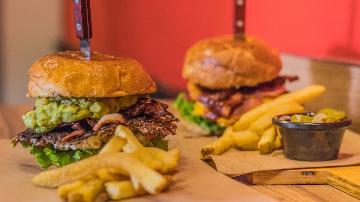 Cool! Burger & Fries exterior on C. Gral. Ignacio Zaragoza, showing the colorful mural and a tray of the signature guacamole burger