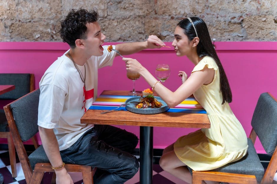 A young couple enjoying a meal at a colorful cafe in CDMX, showcasing vibrant Mexican interiors.
