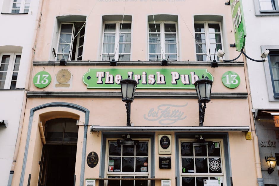 Front view of a classic Irish pub with vintage architecture in an urban street setting.