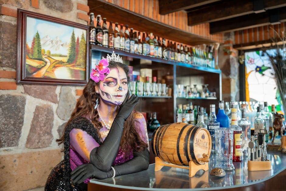 A woman in La Catrina makeup poses in a lively Mexican bar, celebrating Día de los Muertos.