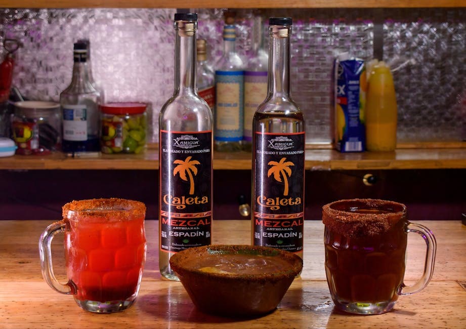 Artisanal mezcal bottles showcased with vibrant cocktails and traditional snacks in a Mexico City bar.