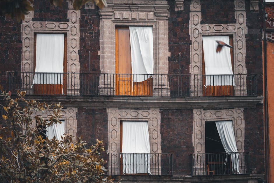 A detailed view of antique balconies and facade in Mexico City, capturing architectural elegance.