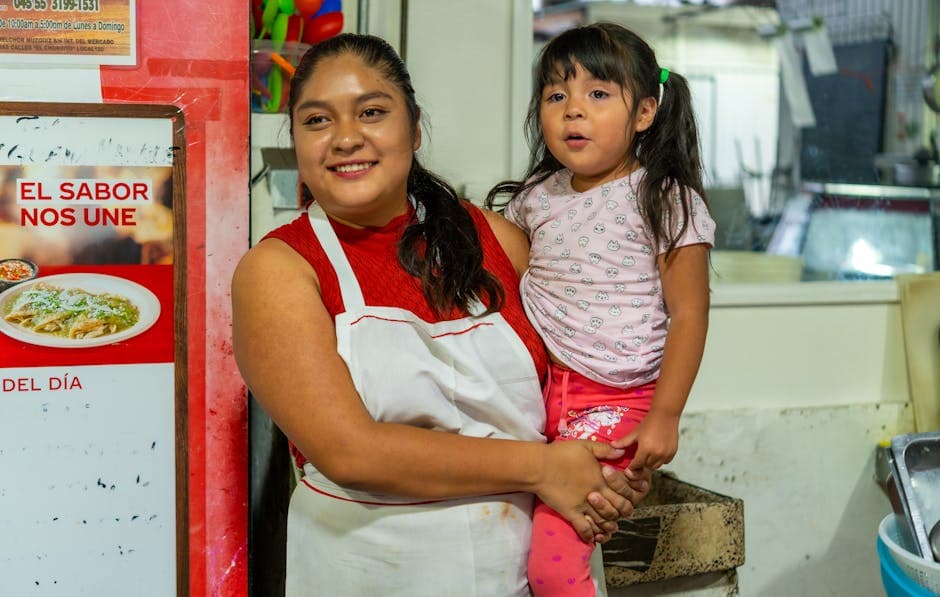 Mother and daughter smiling together in a cozy Ciudad de México eatery.