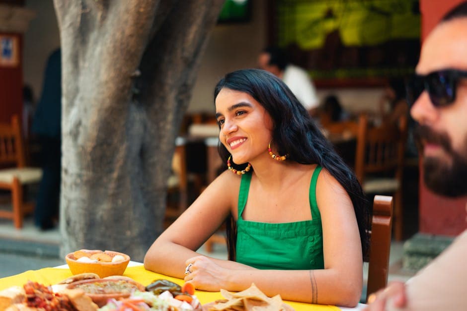 A joyful moment celebrating Mexican culture at an outdoor restaurant with friends
