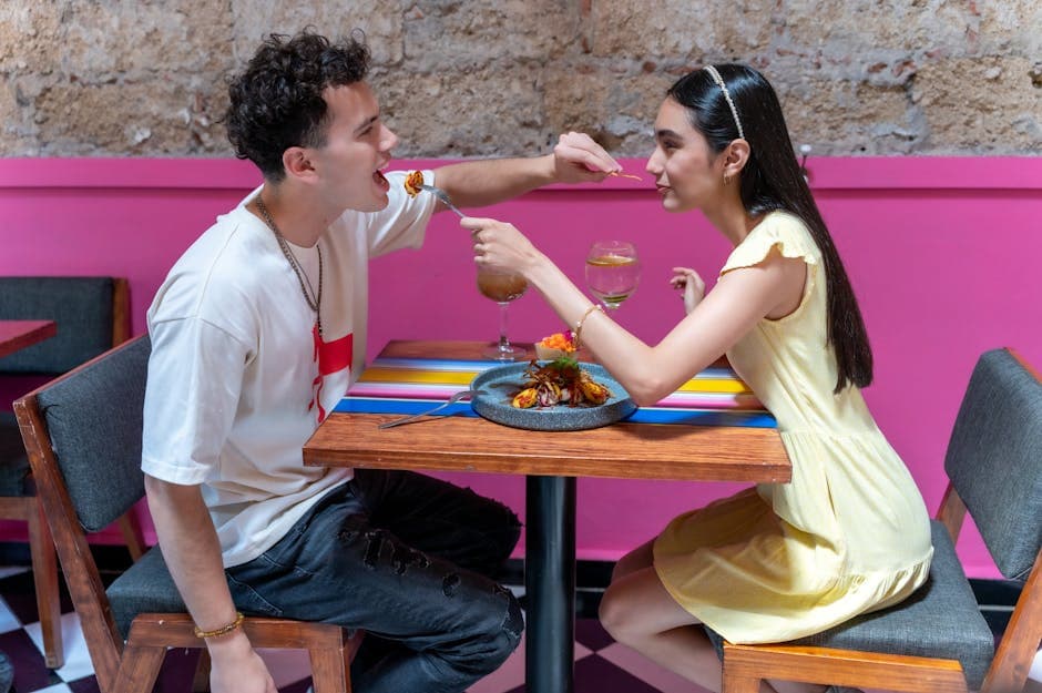 A young couple enjoying a meal at a colorful cafe in CDMX, showcasing vibrant Mexican interiors.