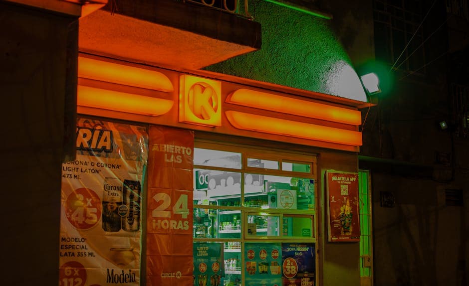 A brightly illuminated convenience store with neon lights at night, showcasing vibrant colors and signage.